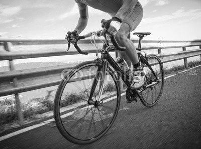Detail of a road bike with a cyclist pedaling