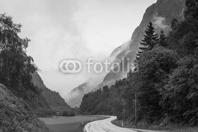 Foggy landscape with road in norwegian mountains