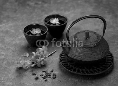 Black iron asian style teapot and cups green tea and flowers