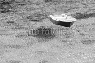 Barca floating in transparent water