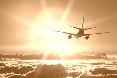 Plane is taking off at sunset
