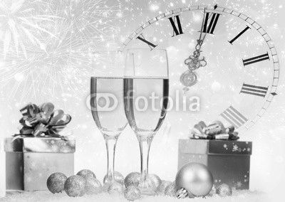 Champagne and gift box against fireworks and holiday lights