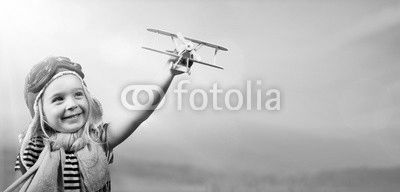 Freedom To Dream - Joyful Child Playing With Airplane Against The Sky
