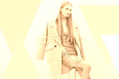 Young elegant woman in trendy pink coat.