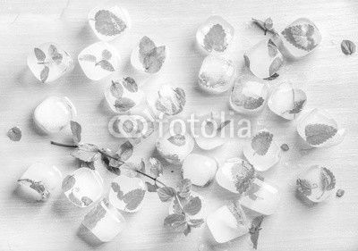 Ice cubes with frozen mint leaves inside on blue Turquoise background
