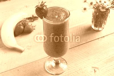 Strawberry banana smoothie in a glass on a table