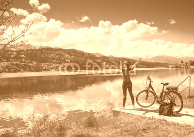 woman with e-bike enjoying view over lake-lake and bike 02
