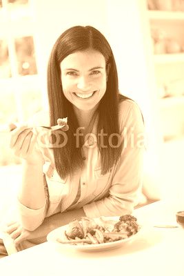 Portrait Of Woman Eating Healthy Meal In Kitchen