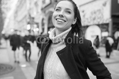 cheerful young woman in the city. feel the spring