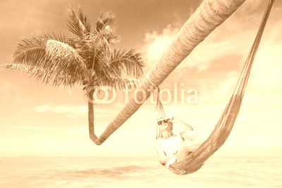 view of nice young lady swinging  in hummock on tropical beach