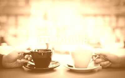 Friends holding cup of coffee