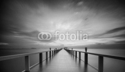 Wooded bridge in the port between sunrise.