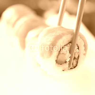picking up a piece of sushi with chopsticks