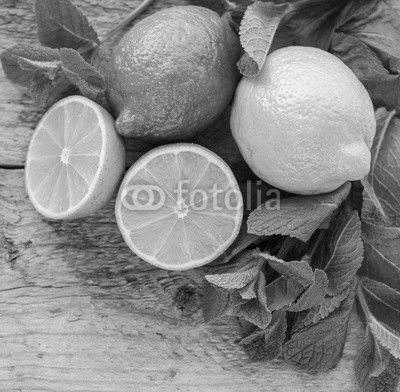 Juicy ripe citrus on an old wooden table - lime, lemon and mint