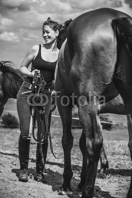 Jockey woman taking care of horse