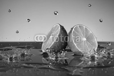 Lime with water drops on grey background