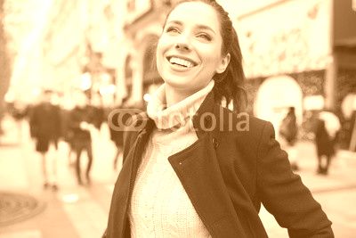 cheerful young woman in the city. feel the spring