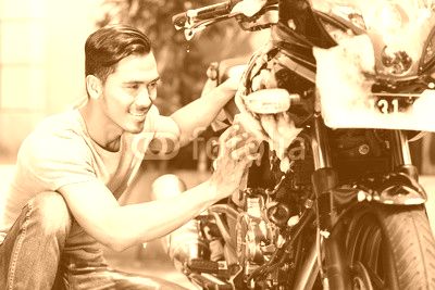 Asian man washing his motorcycle or scooter