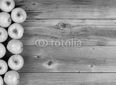 Freshly harvested golden apples on rustic wooden boards