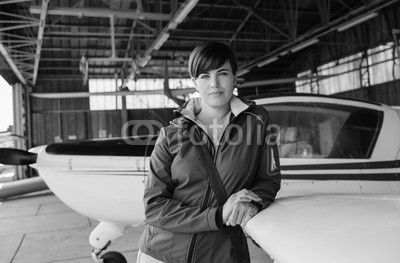 Female pilot posing in the hangar