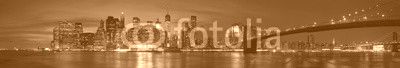 New York city with Brooklyn Bridge, iconic skyline panorama at night in black and white