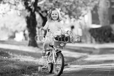 Little girl riding a bike. Child on bicycle.
