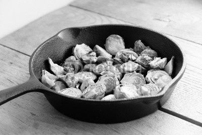 Roasted Brussels sprouts and chestnuts with a balsamic vinegar sauce in a cast iron skillet