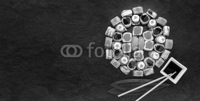 Sushi net on a black surface. Flat lay