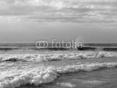 Winter storm at the Black sea, waves splashing on the pier
