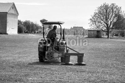 Tractor mowing the grass on the football field