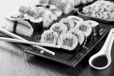Delicious sushi pieces served on black stone