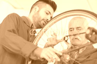 Men looking at bicycle chain