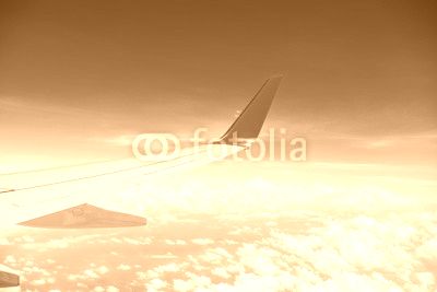 airplane wing above the clouds