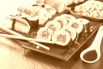 Delicious sushi pieces served on black stone