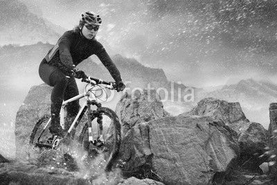 Cyclist climbing on a rock