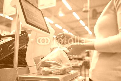 woman weighing potatoes on scale at grocery store