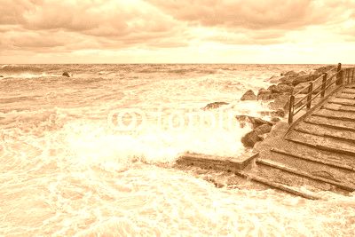 sea in tempest on rocks of italian village