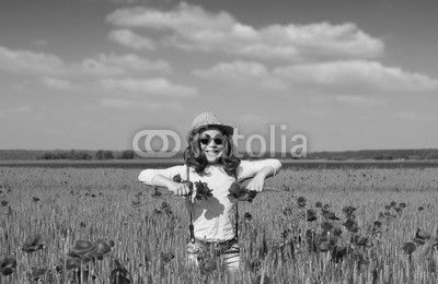 happy little girl on poppies flower field