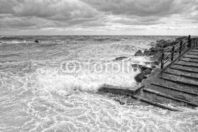 sea in tempest on rocks of italian village