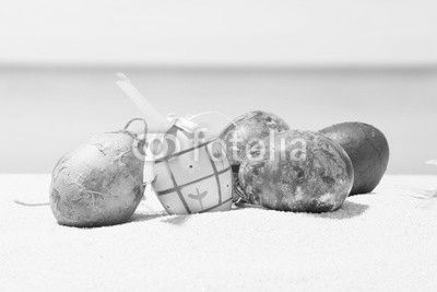 Easter on tropical beach background. Eggs on the white sand. Vacation and travel concept