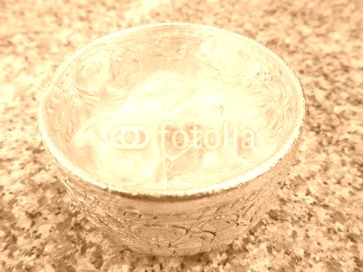 Aluminum bowl with water and  ice cube on the dining table in the restaurant, Thai style