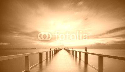 Wooded bridge in the port between sunrise.