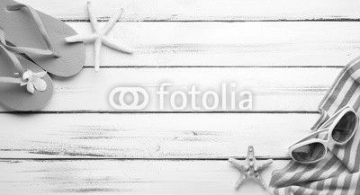 Towel and beach slippers on wood..