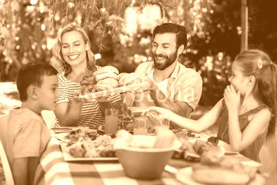 Happy family having meal in yard 