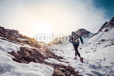 Man running on the snow on a mountain