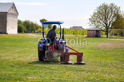 Tractor mowing the grass on the football field