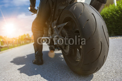 Ready to ride...man on a bike starting a tour with his motorbike on a summer evening