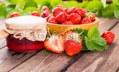 Strawberry on wood background. Strawberry with green leaves.