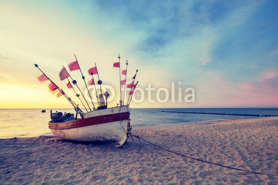 Vintage retro stylized photo of fishing boats on the sea beach