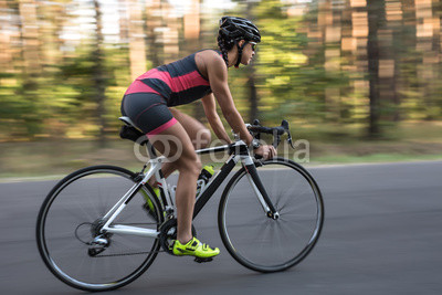Athletic girl rides a bike